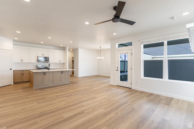 6 S 3830 W Unit 417, West Point, UT 84015 - kitchen with stainless steel microwave, open floor plan, ceiling fan, recessed lighting, and light wood-style floors