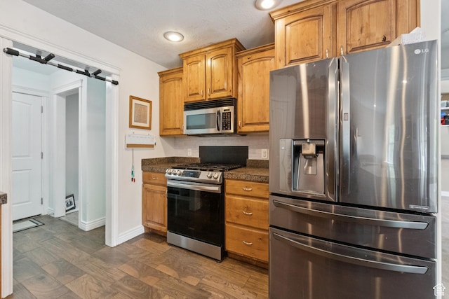 473 W 175 N, Morgan, UT 84050 - kitchen featuring stainless steel appliances, dark countertops, baseboards, brown cabinetry, and recessed lighting