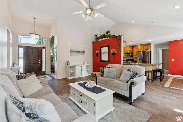 473 W 175 N, Morgan, UT 84050 - living room featuring high vaulted ceiling, arched walkways, a ceiling fan, baseboards, and light wood-style flooring