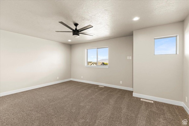178 S Liberty St Unit 206, Grantsville, UT 84029 - spare room featuring ceiling fan, a textured ceiling, dark colored carpet, baseboards, and recessed lighting
