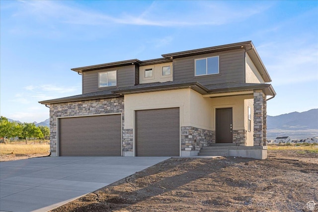 178 S Liberty St Unit 206, Grantsville, UT 84029 - view of front of house with stone siding, a garage, a mountain view, and driveway