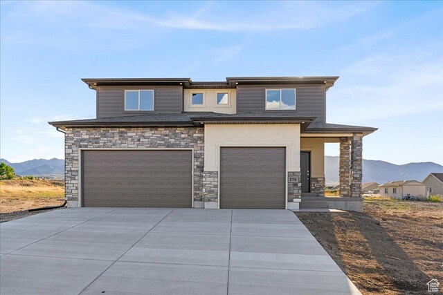 178 S Liberty St Unit 206, Grantsville, UT 84029 - prairie-style home featuring an attached garage, a mountain view, stone siding, and concrete driveway