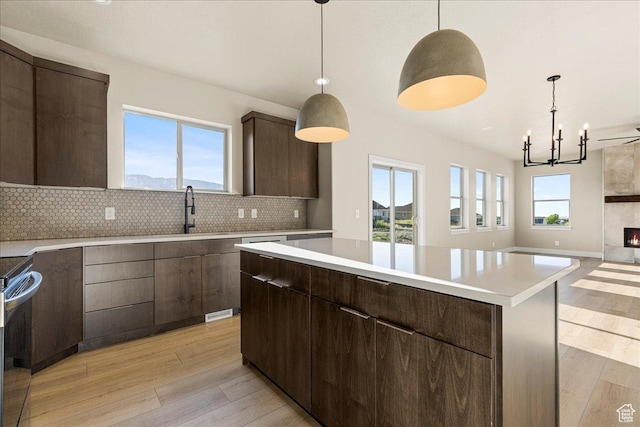 178 S Liberty St Unit 206, Grantsville, UT 84029 - kitchen with a sink, light wood finished floors, light countertops, and decorative backsplash