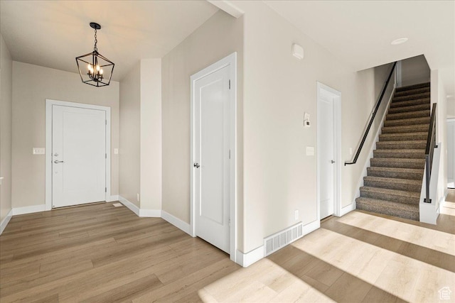 178 S Liberty St Unit 206, Grantsville, UT 84029 - entryway featuring light wood-style floors, stairway, a chandelier, and baseboards