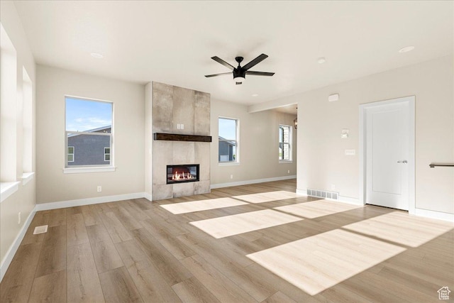 178 S Liberty St Unit 206, Grantsville, UT 84029 - unfurnished living room with ceiling fan, light wood-style floors, baseboards, and a tiled fireplace