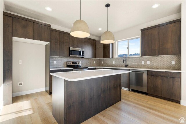 178 S Liberty St Unit 206, Grantsville, UT 84029 - kitchen with stainless steel appliances, dark brown cabinetry, light wood-style flooring, and recessed lighting