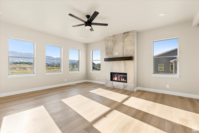 178 S Liberty St Unit 206, Grantsville, UT 84029 - unfurnished living room with baseboards, a fireplace, wood finished floors, ceiling fan, and recessed lighting