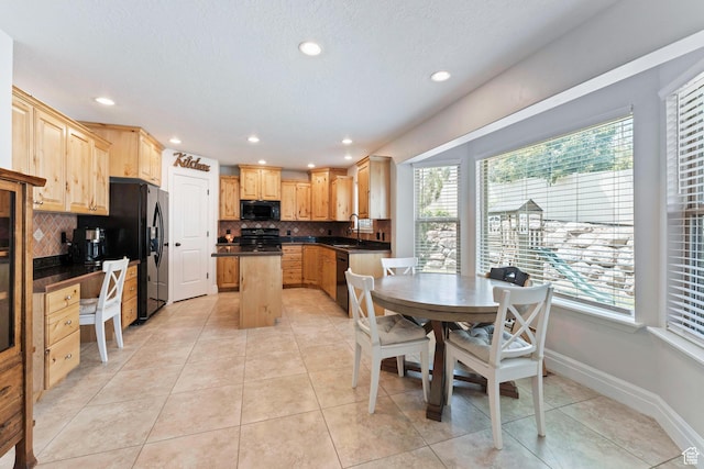 2367 S Wesson Dr, Saratoga Springs, UT 84045 - kitchen with dark countertops, black appliances, plenty of natural light, and recessed lighting