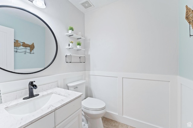 2367 S Wesson Dr, Saratoga Springs, UT 84045 - bathroom with vanity, wainscoting, a decorative wall, toilet, and tile patterned floors