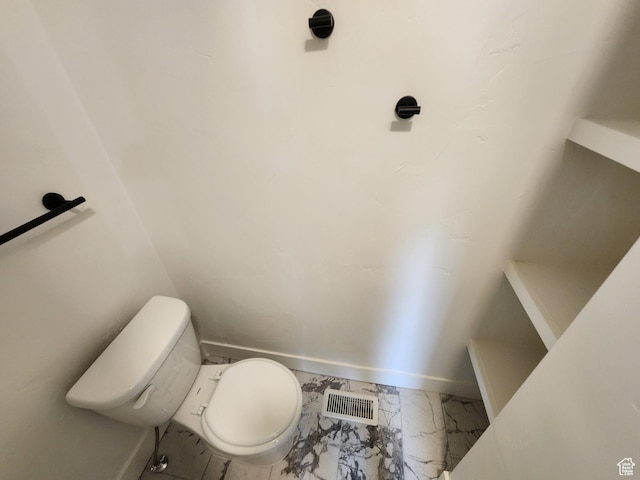 930 E 22nd St, Ogden, UT 84401 - bathroom featuring marble look tiles, toilet, and baseboards