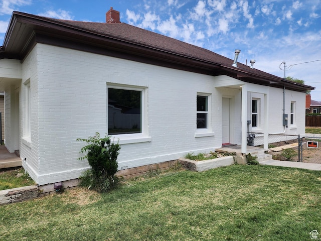 930 E 22nd St, Ogden, UT 84401 - view of home's exterior featuring brick siding and a chimney