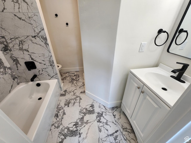 930 E 22nd St, Ogden, UT 84401 - bathroom with marble look tiles, baseboards, vanity, and toilet