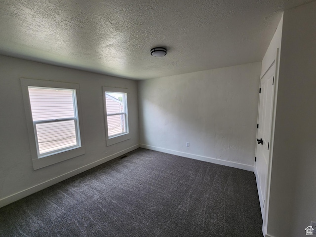 930 E 22nd St, Ogden, UT 84401 - spare room with dark carpet, a textured ceiling, and baseboards
