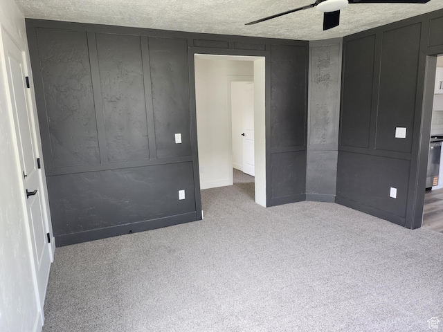 930 E 22nd St, Ogden, UT 84401 - unfurnished bedroom with carpet floors, a ceiling fan, a textured ceiling, and baseboards
