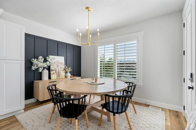 722 N Meridian Dr, Saratoga Springs, UT 84045 - dining area featuring a chandelier, light wood-type flooring, and baseboards