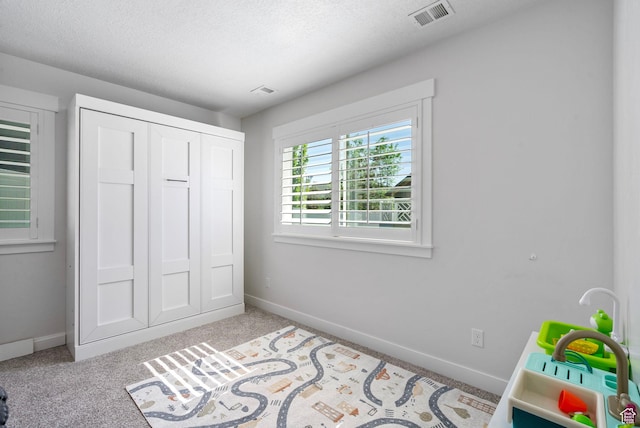 722 N Meridian Dr, Saratoga Springs, UT 84045 - bedroom featuring baseboards, carpet flooring, a closet, and a textured ceiling