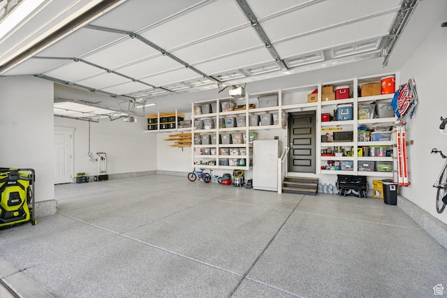 722 N Meridian Dr, Saratoga Springs, UT 84045 - garage featuring freestanding refrigerator, a garage door opener, and baseboards