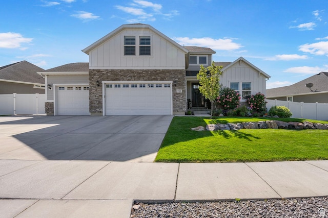 722 N Meridian Dr, Saratoga Springs, UT 84045 - view of front of property featuring board and batten siding, stone siding, driveway, and an attached garage