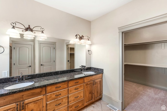 1596 E Millbrook Way S, Bountiful, UT 84010 - bathroom featuring double vanity, a spacious closet, and baseboards