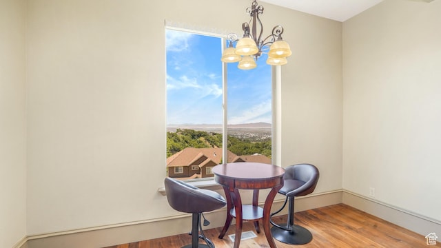 1596 E Millbrook Way S, Bountiful, UT 84010 - dining space featuring wood finished floors, a chandelier, and baseboards