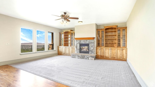 1596 E Millbrook Way S, Bountiful, UT 84010 - unfurnished living room with a fireplace, ceiling fan, baseboards, and light wood-style floors