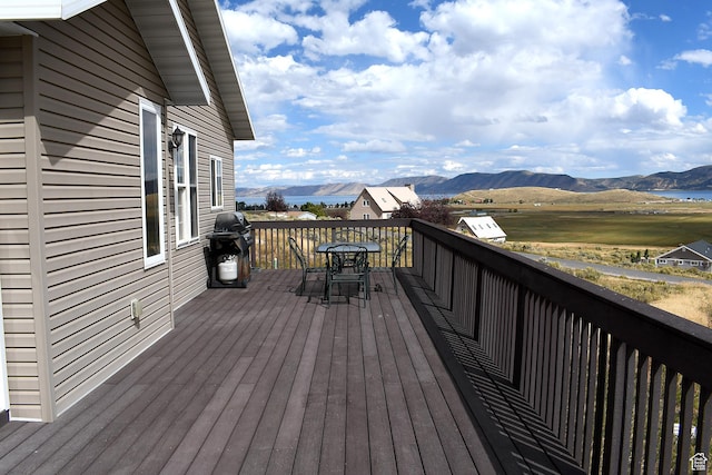 45 Wedge Way, Garden City, UT 84028 - wooden terrace featuring outdoor dining area, a mountain view, and a grill
