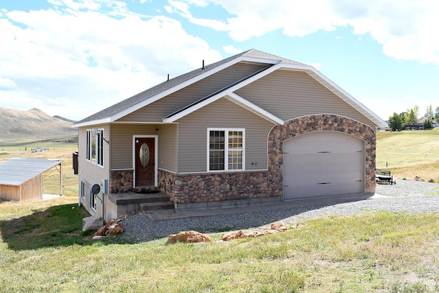 45 Wedge Way, Garden City, UT 84028 - view of front facade featuring stone siding, an attached garage, a front yard, and driveway