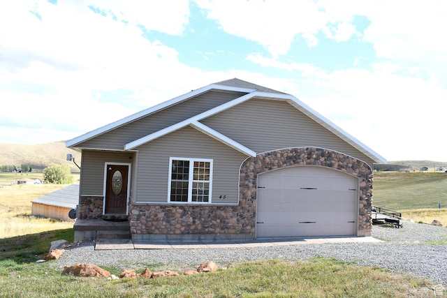 45 Wedge Way, Garden City, UT 84028 - view of front facade with stone siding, an attached garage, and gravel driveway