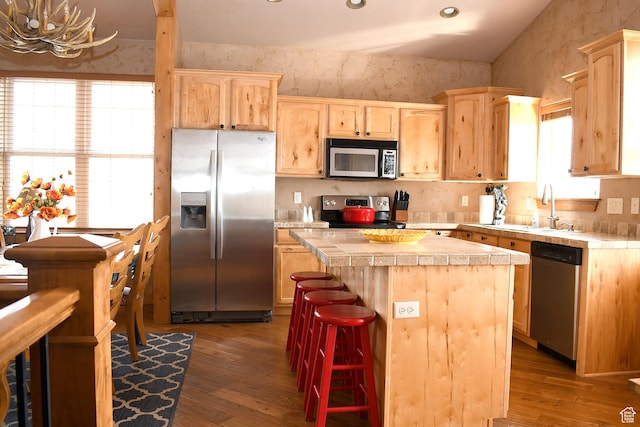 45 Wedge Way, Garden City, UT 84028 - kitchen featuring appliances with stainless steel finishes, light brown cabinetry, a center island, and wood-type flooring