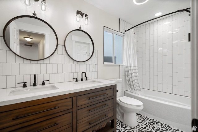 3355 E Golden Eagle Rd, Eagle Mountain, UT 84005 - full bathroom featuring double vanity, shower / bath combo with shower curtain, toilet, backsplash, and tile patterned flooring