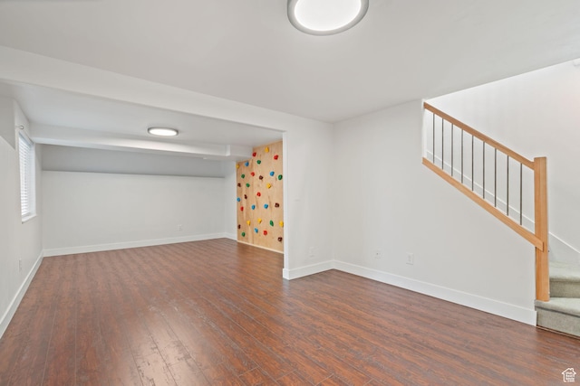 3355 E Golden Eagle Rd, Eagle Mountain, UT 84005 - spare room featuring dark wood-type flooring, baseboards, and stairway