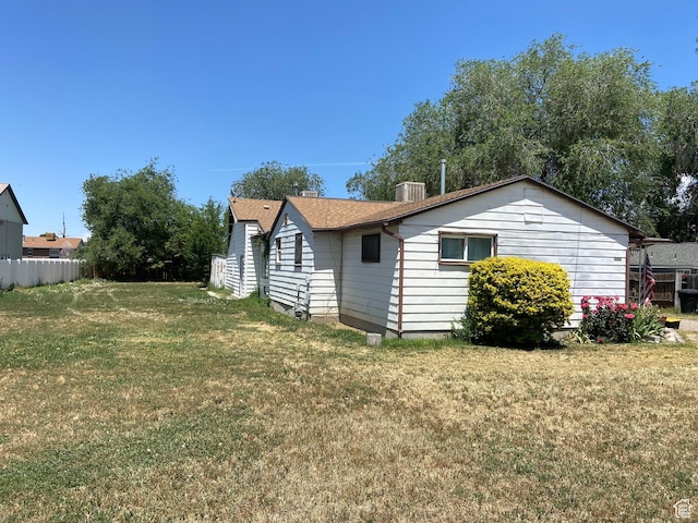 1802 W 5000 S, Taylorsville, UT 84129 - view of home's exterior with a lawn and a shingled roof