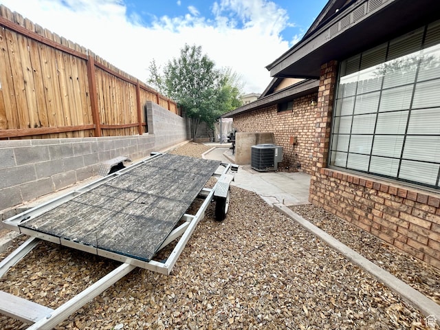 344 E Vermillion Ave, St George, UT 84790 - exterior view of brick siding, a fenced backyard, and central AC