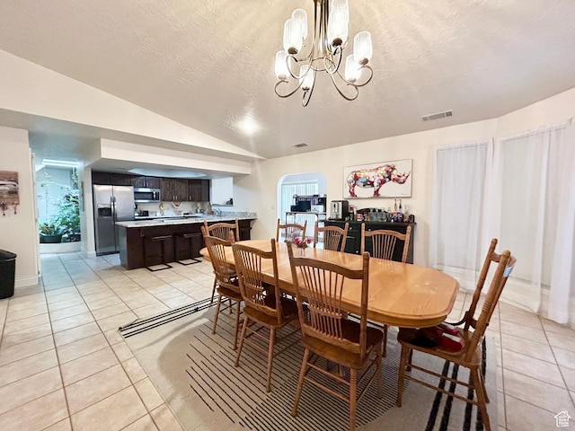 344 E Vermillion Ave, St George, UT 84790 - dining room featuring light tile patterned flooring, a chandelier, lofted ceiling, and a textured ceiling