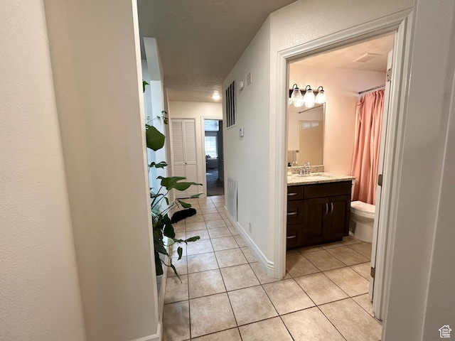 344 E Vermillion Ave, St George, UT 84790 - bathroom with tile patterned flooring, vanity, toilet, and a shower with shower curtain