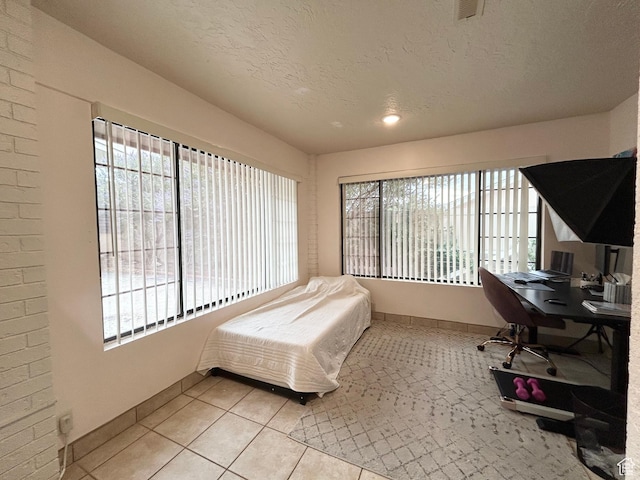 344 E Vermillion Ave, St George, UT 84790 - bedroom with tile patterned floors, a desk, and a textured ceiling