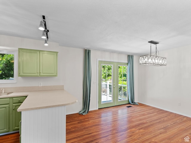 544 W 425 S, Layton, UT 84041 - kitchen featuring green cabinets, a peninsula, light countertops, french doors, and wood finished floors