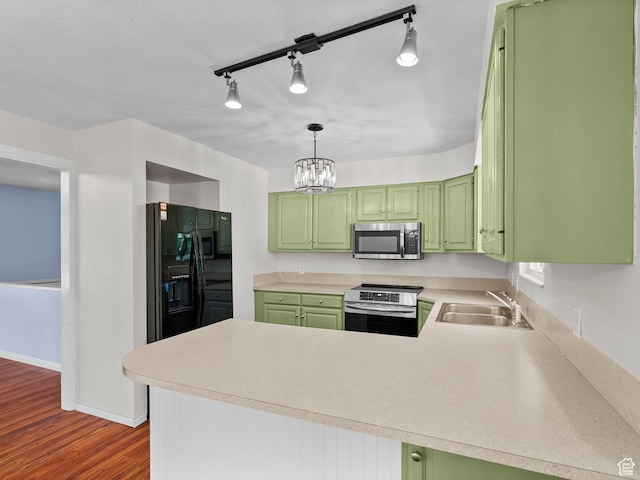 544 W 425 S, Layton, UT 84041 - kitchen featuring appliances with stainless steel finishes, a sink, green cabinets, a peninsula, and light countertops