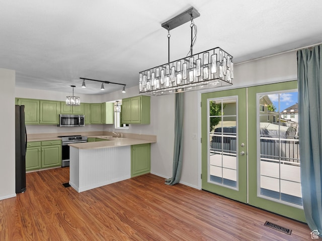 544 W 425 S, Layton, UT 84041 - kitchen with green cabinetry, appliances with stainless steel finishes, a chandelier, and a sink