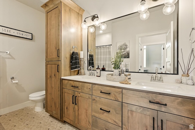 4657 W 275 N, Cedar City, UT 84720 - bathroom with double vanity, baseboards, and toilet