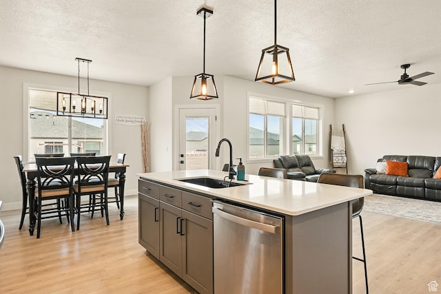 4657 W 275 N, Cedar City, UT 84720 - kitchen with stainless steel dishwasher, a sink, light wood-type flooring, plenty of natural light, and a textured ceiling