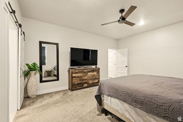 4657 W 275 N, Cedar City, UT 84720 - bedroom featuring a barn door, carpet, baseboards, and a ceiling fan