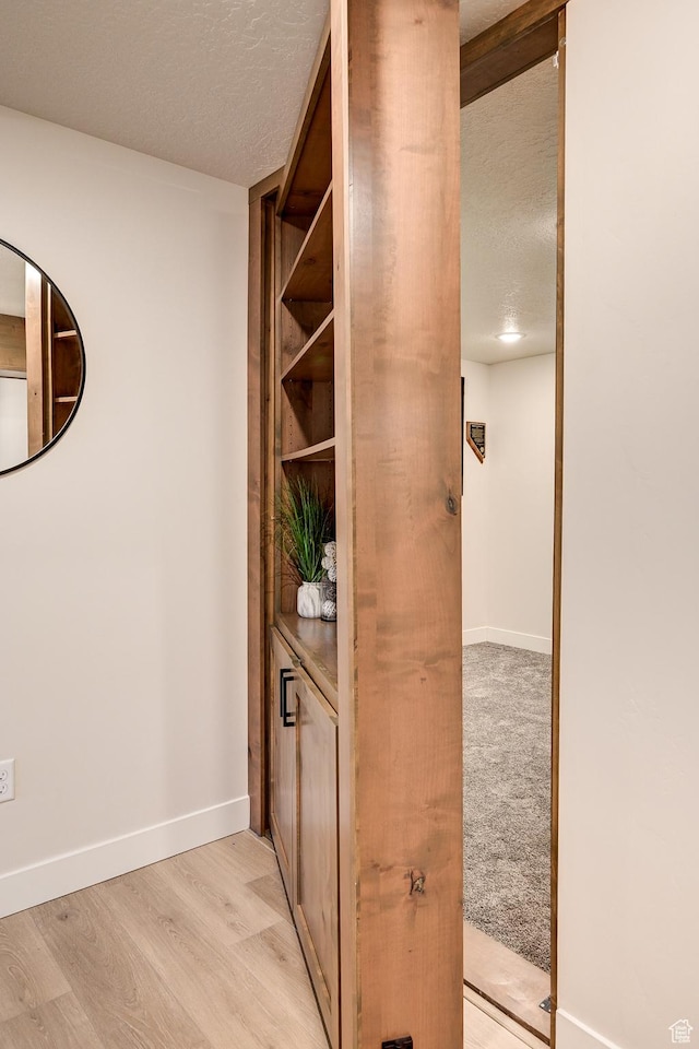 4657 W 275 N, Cedar City, UT 84720 - hallway with light wood finished floors, a textured ceiling, and baseboards