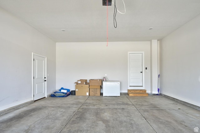 4657 W 275 N, Cedar City, UT 84720 - garage featuring refrigerator, a garage door opener, and baseboards