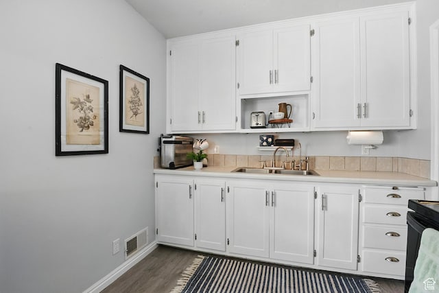 8757 W Helen Dr, Magna, UT 84044 - kitchen with a sink, white cabinetry, light countertops, and dark wood finished floors