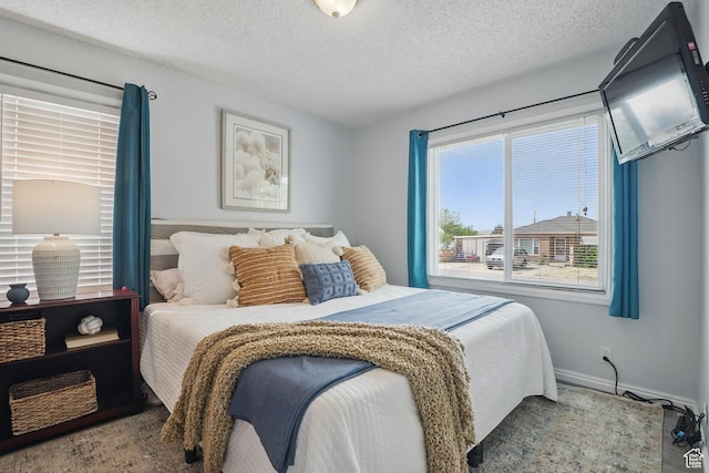 8757 W Helen Dr, Magna, UT 84044 - bedroom with multiple windows, a textured ceiling, and baseboards