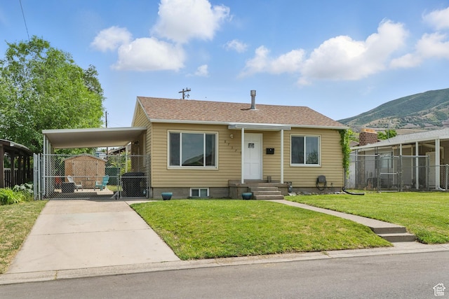 8757 W Helen Dr, Magna, UT 84044 - view of front of house featuring a gate, concrete driveway, a carport, and a mountain view