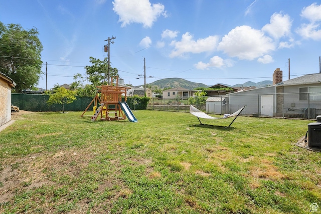 8757 W Helen Dr, Magna, UT 84044 - view of yard with a playground and a storage shed