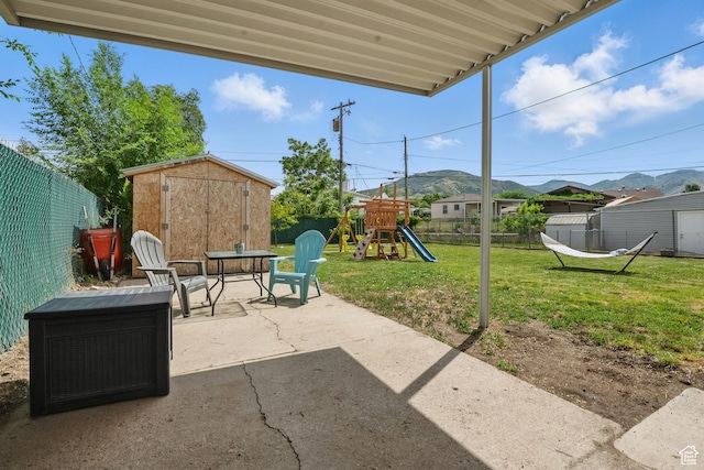 8757 W Helen Dr, Magna, UT 84044 - view of patio with a playground and a mountain view