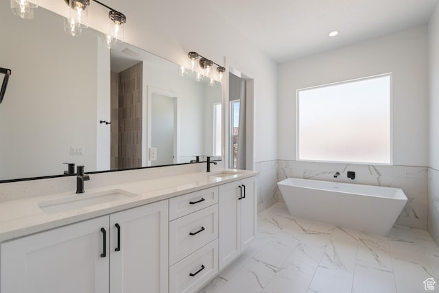 824 S 1690 W, Hurricane, UT 84737 - full bathroom featuring double vanity, a freestanding bath, marble finish flooring, and recessed lighting
